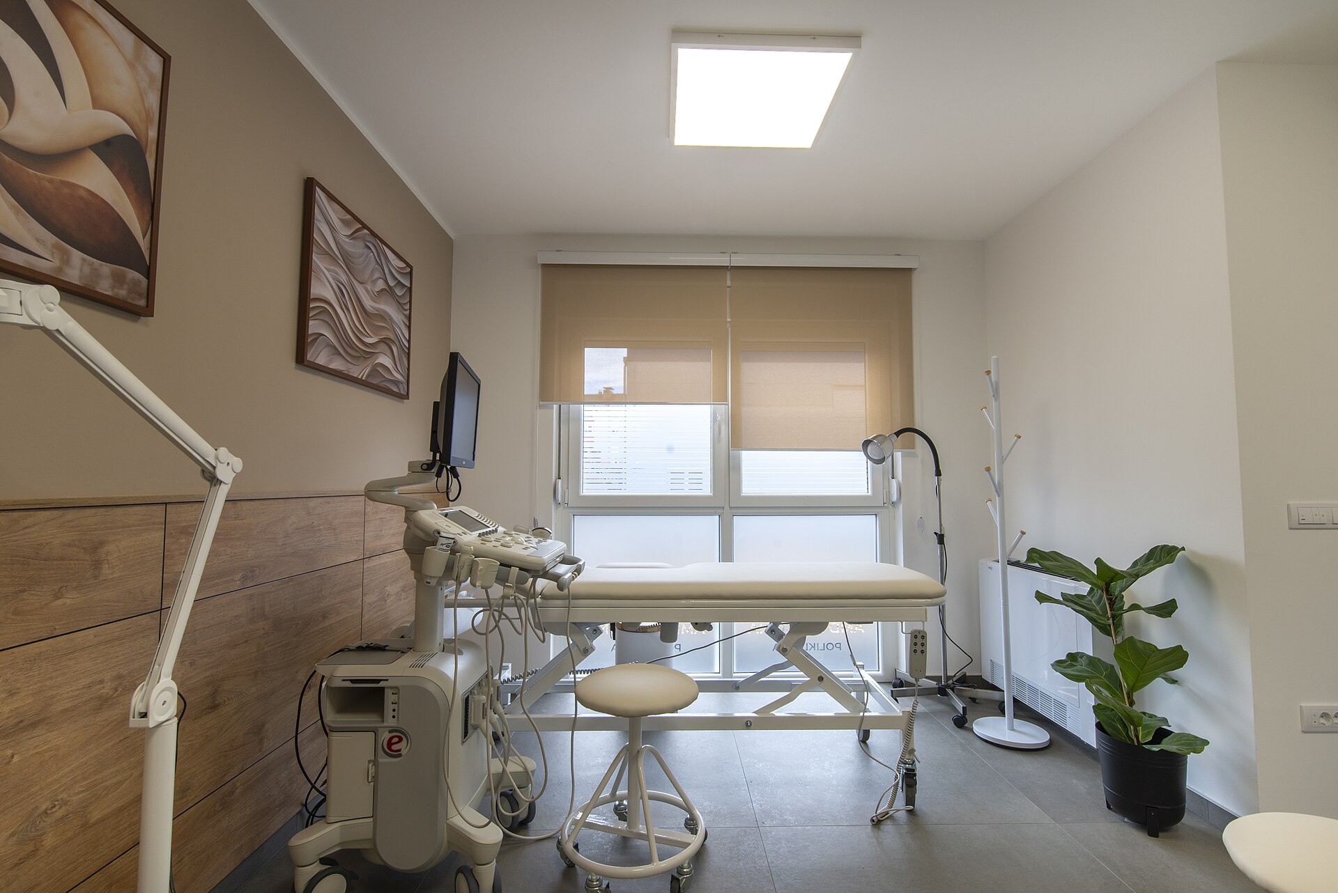 Bright modern medical examination room with coordinated clinical furniture